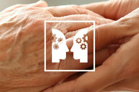 care worker and elderly lady holding hands