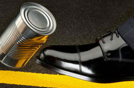 business man kicking can