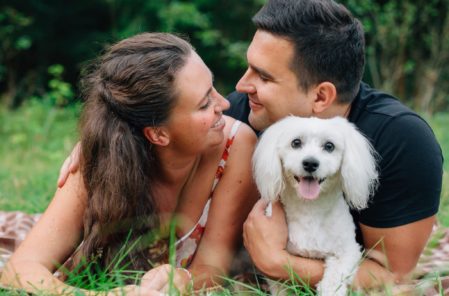 couple with dog on grass